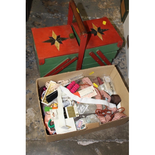 127 - A QUANTITY OF SEWING ACCESSORIES TO INCLUDE A PAINTED FOLD OUT SEWING BOX AND CONTENTS