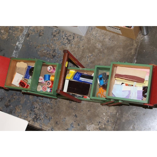 127 - A QUANTITY OF SEWING ACCESSORIES TO INCLUDE A PAINTED FOLD OUT SEWING BOX AND CONTENTS