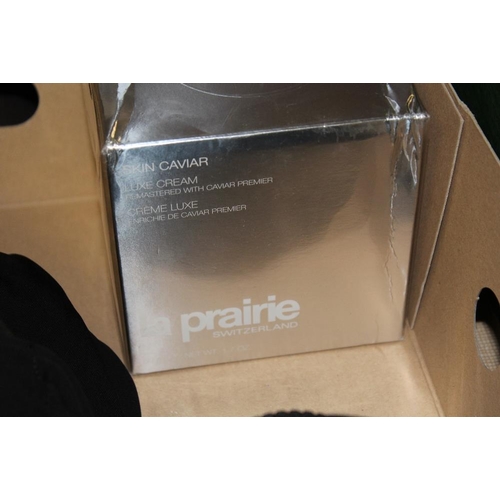 142 - A TRAY OF DESIGNER STYLE CLOTHING AND ACCESSORIES TO INCLUDE PURSES, LA PRAIRIE SKIN CAVIAR ETC.