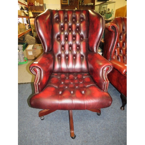 728 - AN OXBLOOD LEATHER OFFICE SWIVEL WINGBACK ARMCHAIR