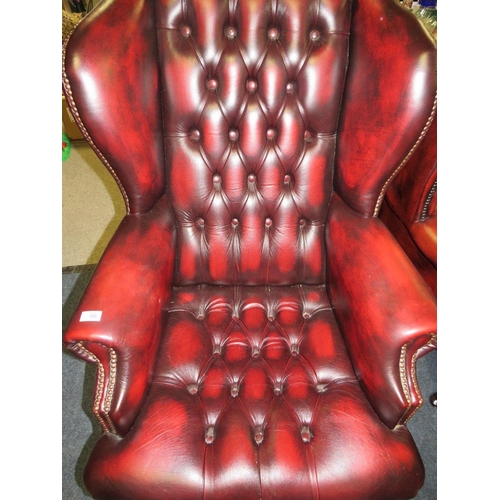 728 - AN OXBLOOD LEATHER OFFICE SWIVEL WINGBACK ARMCHAIR