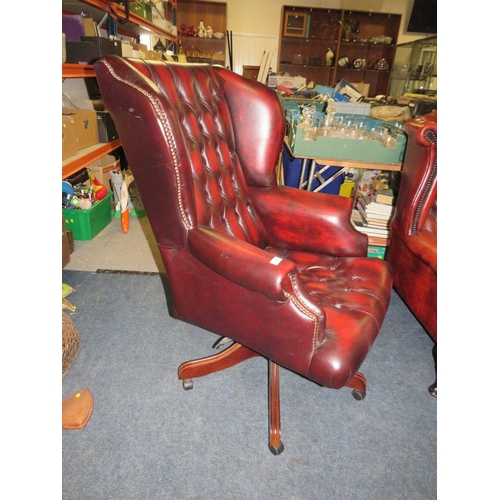 728 - AN OXBLOOD LEATHER OFFICE SWIVEL WINGBACK ARMCHAIR