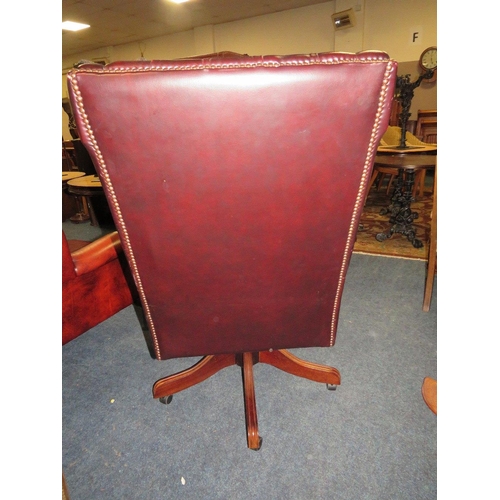 728 - AN OXBLOOD LEATHER OFFICE SWIVEL WINGBACK ARMCHAIR