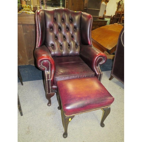 735 - AN OXBLOOD RED LEATHER WINGBACK ARMCHAIR BY MARTIN BARNES LONDON TOGETHER WITH A STOOL