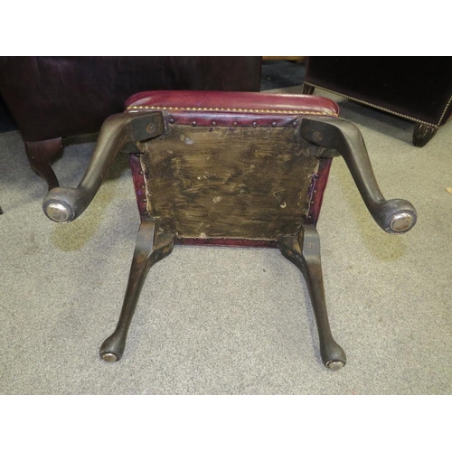 735 - AN OXBLOOD RED LEATHER WINGBACK ARMCHAIR BY MARTIN BARNES LONDON TOGETHER WITH A STOOL