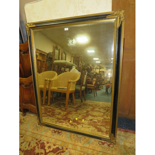 778 - A LARGE MODERN BLACK AND GILT RECTANGULAR WALL MIRROR 138 X 106 CM
