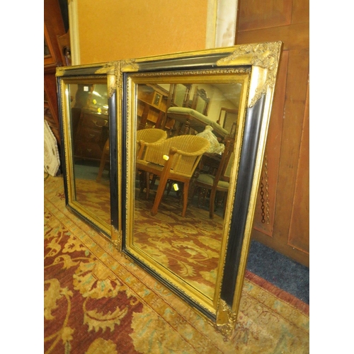 779 - A PAIR OF  MODERN BLACK AND GILT RECTANGULAR WALL MIRRORS 94 X 69 CM (2)