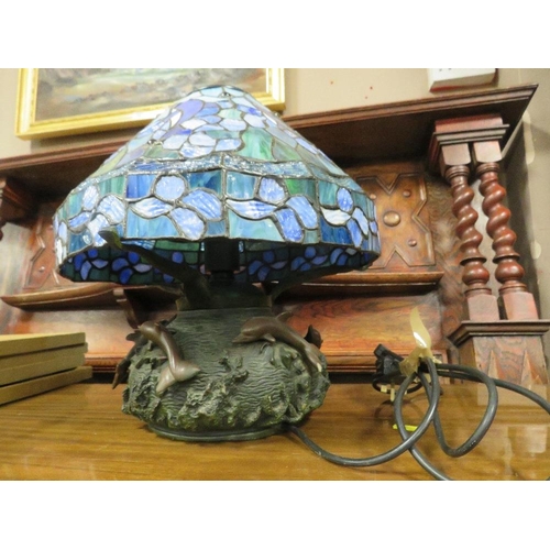 781 - A TIFFANY STYLE TABLE LAMP WITH A BRONZED STYLE DOLPHIN BASE A/F H-38 CM (OVERALL)