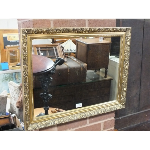 730 - A MODERN GILT RECTANGULAR MIRROR 55 X 70 CM