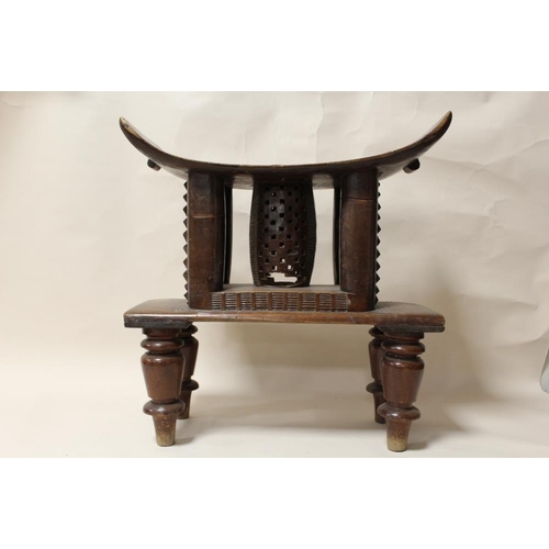 116 - A GHANAIAN ASHANTI HARDWOOD STOOL, with later added feet, overall H 55 cm, without feet H 33.5 cm