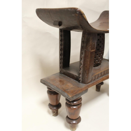 116 - A GHANAIAN ASHANTI HARDWOOD STOOL, with later added feet, overall H 55 cm, without feet H 33.5 cm