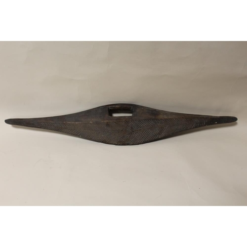 120 - AN AUSTRALIAN ABORIGINAL PARRYING SHIELD, flattened with incised decoration, L 84 cm