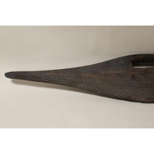 120 - AN AUSTRALIAN ABORIGINAL PARRYING SHIELD, flattened with incised decoration, L 84 cm