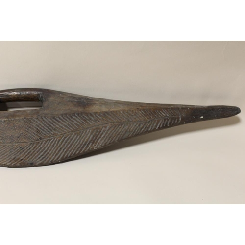 120 - AN AUSTRALIAN ABORIGINAL PARRYING SHIELD, flattened with incised decoration, L 84 cm