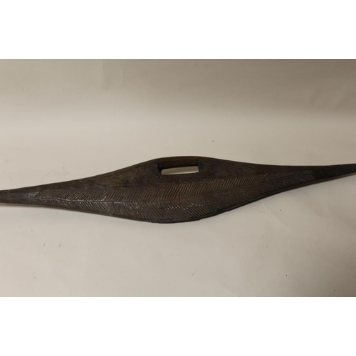 120 - AN AUSTRALIAN ABORIGINAL PARRYING SHIELD, flattened with incised decoration, L 84 cm