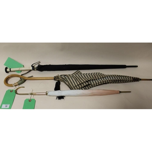 95 - THREE EARLY / MID TWENTIETH CENTURY VINTAGE PARASOLS, one having a carved handle in the form of a du... 