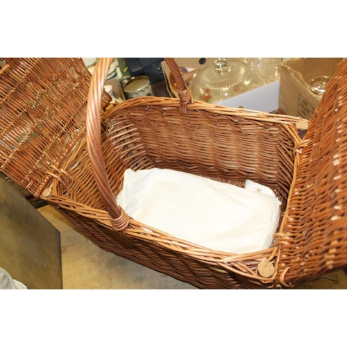 114 - A WICKER HAMPER BASKET CONTAINING VINTAGE EVENING WARE AND A VINTAGE ROLLER EYE DOLL MARKED 037-3 1/... 