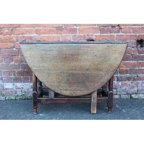 828 - A NINETEENTH CENTURY OAK DROPLEAF GATE LEG TABLE, H 69 cm W 141 cm