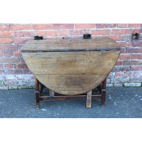 828 - A NINETEENTH CENTURY OAK DROPLEAF GATE LEG TABLE, H 69 cm W 141 cm