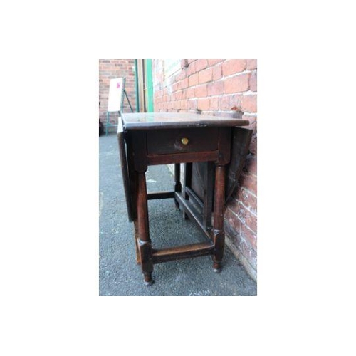 828 - A NINETEENTH CENTURY OAK DROPLEAF GATE LEG TABLE, H 69 cm W 141 cm