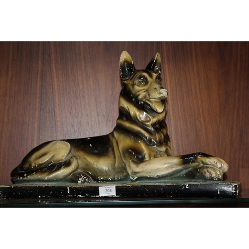 296 - A VINTAGE CHALK FIGURE OF AN ALSATIAN FIGURE W 57 CM, TOGETHER WITH A FIRESIDE SEATED CHEETAH FIGURE... 