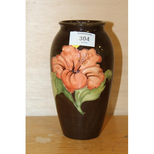 304 - A BROWN MOORCROFT HIBISCUS PATTERN VASE