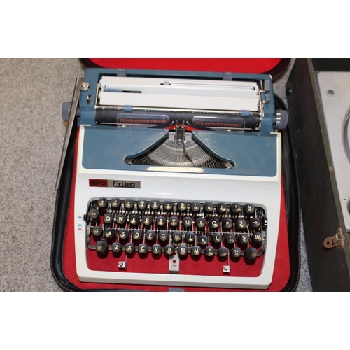 319 - A VINTAGE HMV POTABLE RECORD PLAYER TOGETHER WITH A CASED TYPE WRITER