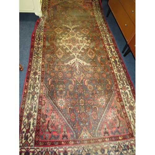 841 - A PERSIAN WOOLLEN RUNNER / CARPET, MAINLY RED AND BLACK GROUND - FADED -  282 X 131 CM