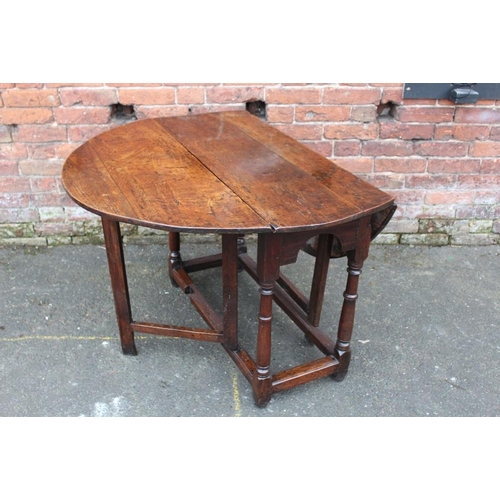 1025 - AN ANTIQUE OAK DROPLEAF DINING TABLE, with typical gateleg mechanism, Dia. 125 cm