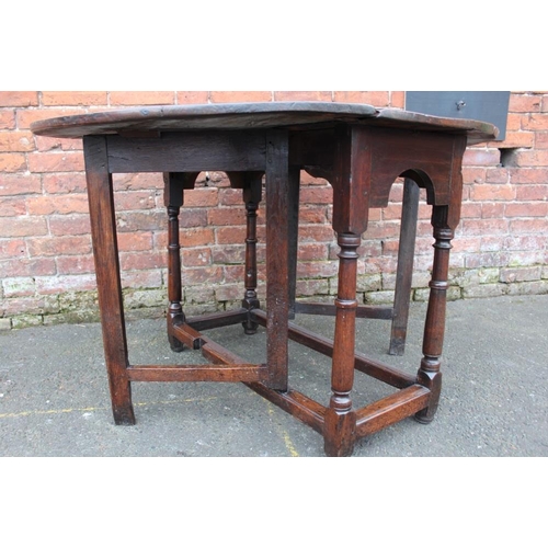 1025 - AN ANTIQUE OAK DROPLEAF DINING TABLE, with typical gateleg mechanism, Dia. 125 cm