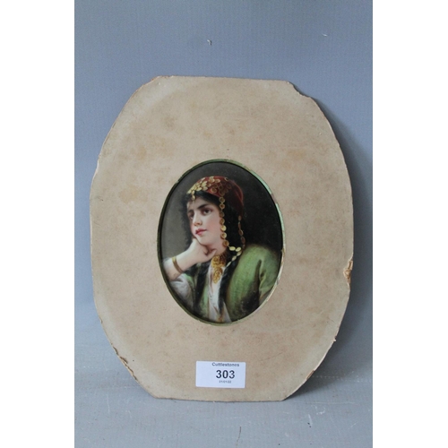 303 - A 19TH CENTURY CONTINENTAL OVAL PORCELAIN PLAQUE DEPICTING A LADY IN AN ELABORATE HEAD DRESS, paper ... 