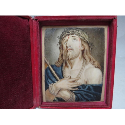 267 - (XIX). A miniature on ivory of Jesus Christ wearing a crown of thorns, unsigned, set in leather cove... 