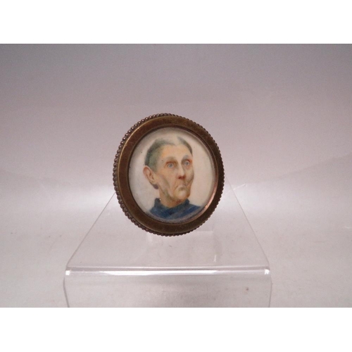 280 - (XX). A circular portrait miniature on ivory of a head and shoulder study of a man with blue jumper,... 