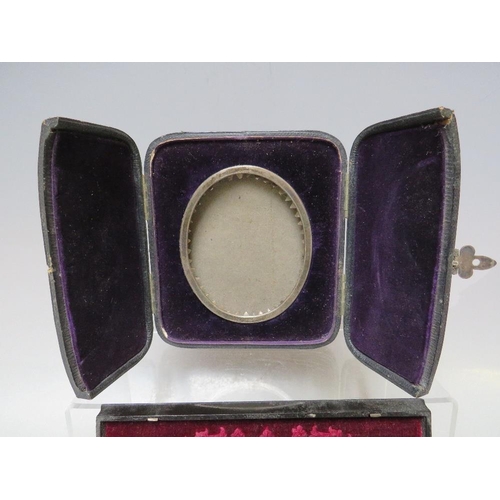 291 - A 19TH CENTURY OVAL WHITE METAL PORTRAIT MINIATURE FRAME, set in a leather covered strut back case, ... 