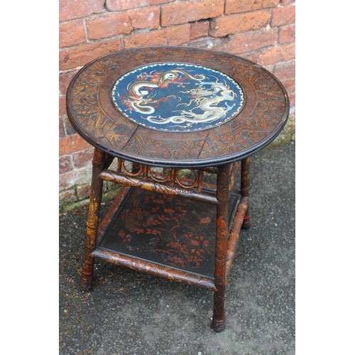 1028 - A CHINESE STYLE HARDWOOD CIRCULAR FAUX BAMBOO TABLE WITH INSET CIRCULAR CLOISONNE PLAQUE, the hardwo... 