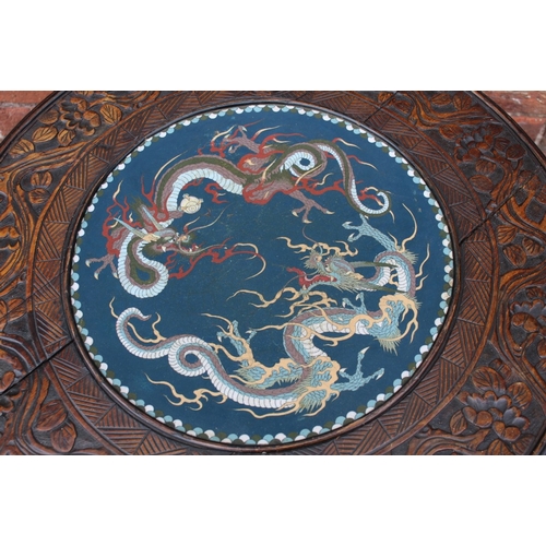 1028 - A CHINESE STYLE HARDWOOD CIRCULAR FAUX BAMBOO TABLE WITH INSET CIRCULAR CLOISONNE PLAQUE, the hardwo... 