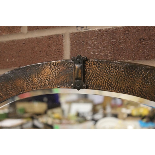 118 - A COPPER FRAMED ARTS AND CRAFTS STYLE OVAL WALL MIRROR - OVERALL 60CM X 86CM