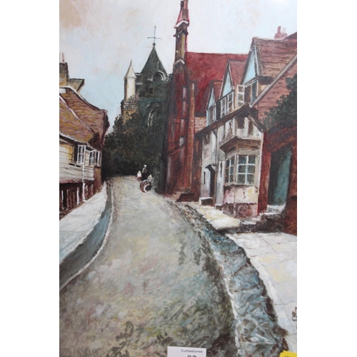 63 - A FRAMED AND GLAZED OIL PAINTING OF A VILLAGE STREET SCENE MONOGRAMMED LOWER RIGHT 38.5CM X 26CM