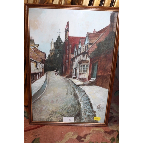 63 - A FRAMED AND GLAZED OIL PAINTING OF A VILLAGE STREET SCENE MONOGRAMMED LOWER RIGHT 38.5CM X 26CM