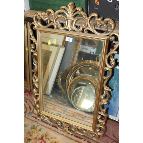79 - A REPRODUCTION GILT PIERCED FRAMED WALL MIRROR OVERALL SIZE - 90CM X 57CM