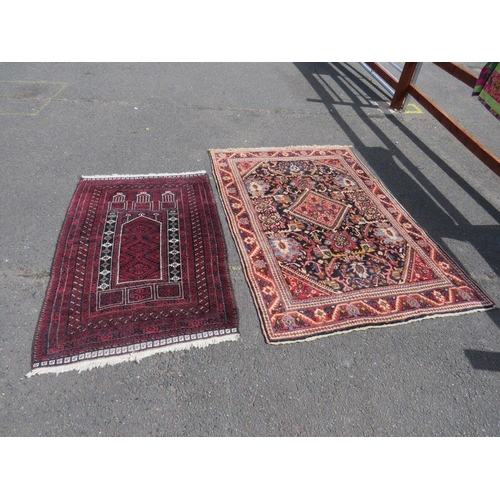 695 - TWO EARLY 20TH CENTURY RED/PINK WOOLLEN RUGS, LARGEST 208 X 136 CM , SMALLEST 163 X 96 CM(2)