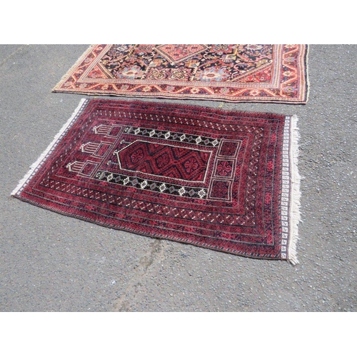 695 - TWO EARLY 20TH CENTURY RED/PINK WOOLLEN RUGS, LARGEST 208 X 136 CM , SMALLEST 163 X 96 CM(2)