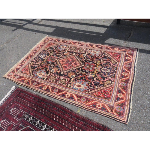 695 - TWO EARLY 20TH CENTURY RED/PINK WOOLLEN RUGS, LARGEST 208 X 136 CM , SMALLEST 163 X 96 CM(2)