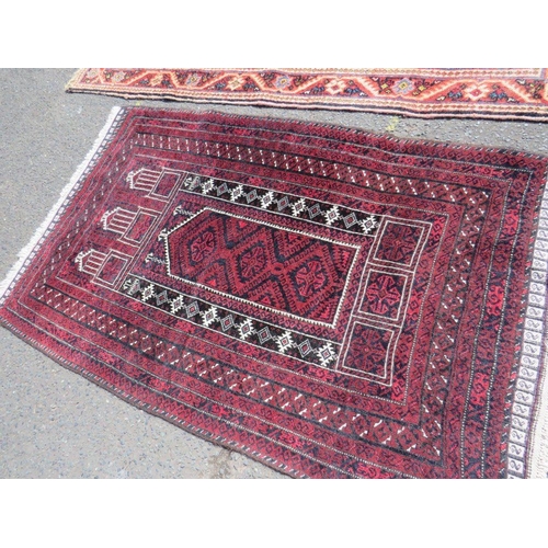 695 - TWO EARLY 20TH CENTURY RED/PINK WOOLLEN RUGS, LARGEST 208 X 136 CM , SMALLEST 163 X 96 CM(2)