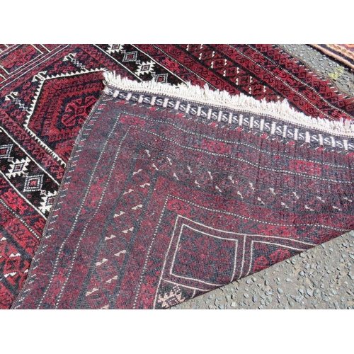 695 - TWO EARLY 20TH CENTURY RED/PINK WOOLLEN RUGS, LARGEST 208 X 136 CM , SMALLEST 163 X 96 CM(2)