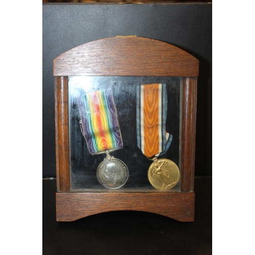 337 - A PAIR OF WWI MEDALS AWARDED TO M-205338 SGT. E.S. CLARKE A.S.C. IN AN OAK GLAZED DISPLAY CASE