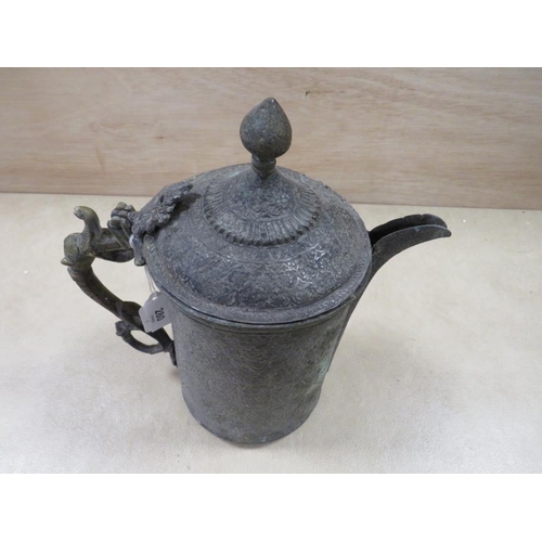 280 - AN ANTIQUE ISLAMIC STYLE METAL POURER EMBOSSED WITH FLORAL DETAIL - H 27 CM