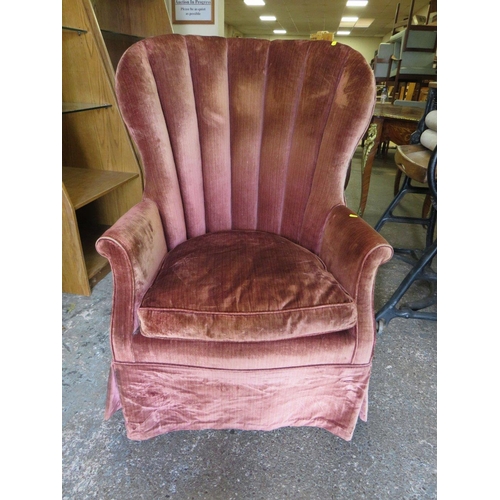 696 - A LARGE VINTAGE UPHOLSTERED TUB TYPE ARMCHAIR