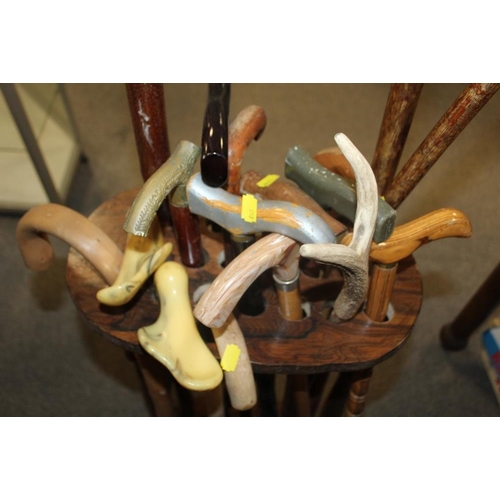 183 - A STICK STAND CONTAINING A LARGE QUANTITY OF ASSORTED WALKING STICKS TO INCLUDE HORN HANDLED EXAMPLE... 