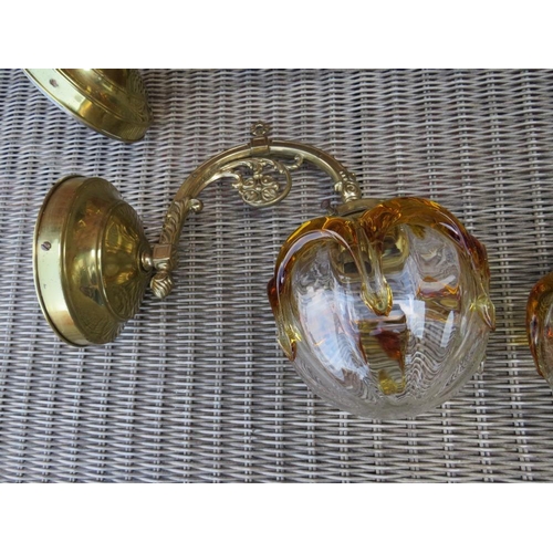 68 - A SET OF FOUR BRASS EFFECT WALL LIGHT FITTINGS WITH RETRO GLASS SHADES